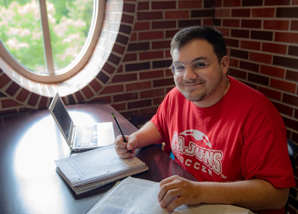 Photo caption: UL Lafayette accounting graduate Zach Wells in a familiar study spot, Moody Hall's second-floor atrium. (Photo credit: Rachel Keyes / University of Louisiana at Lafayette)